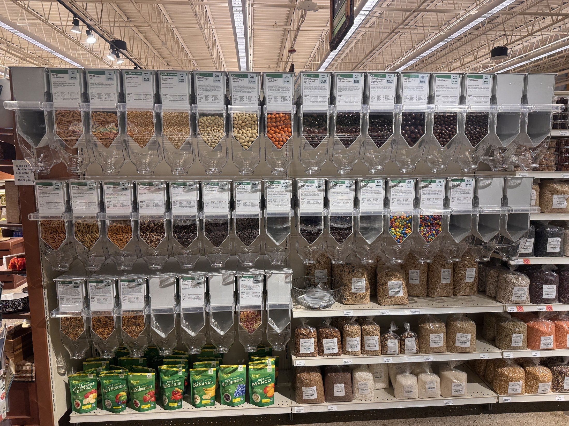 Purcell dispensers stocked with snacks and bulk foods on retail shelving