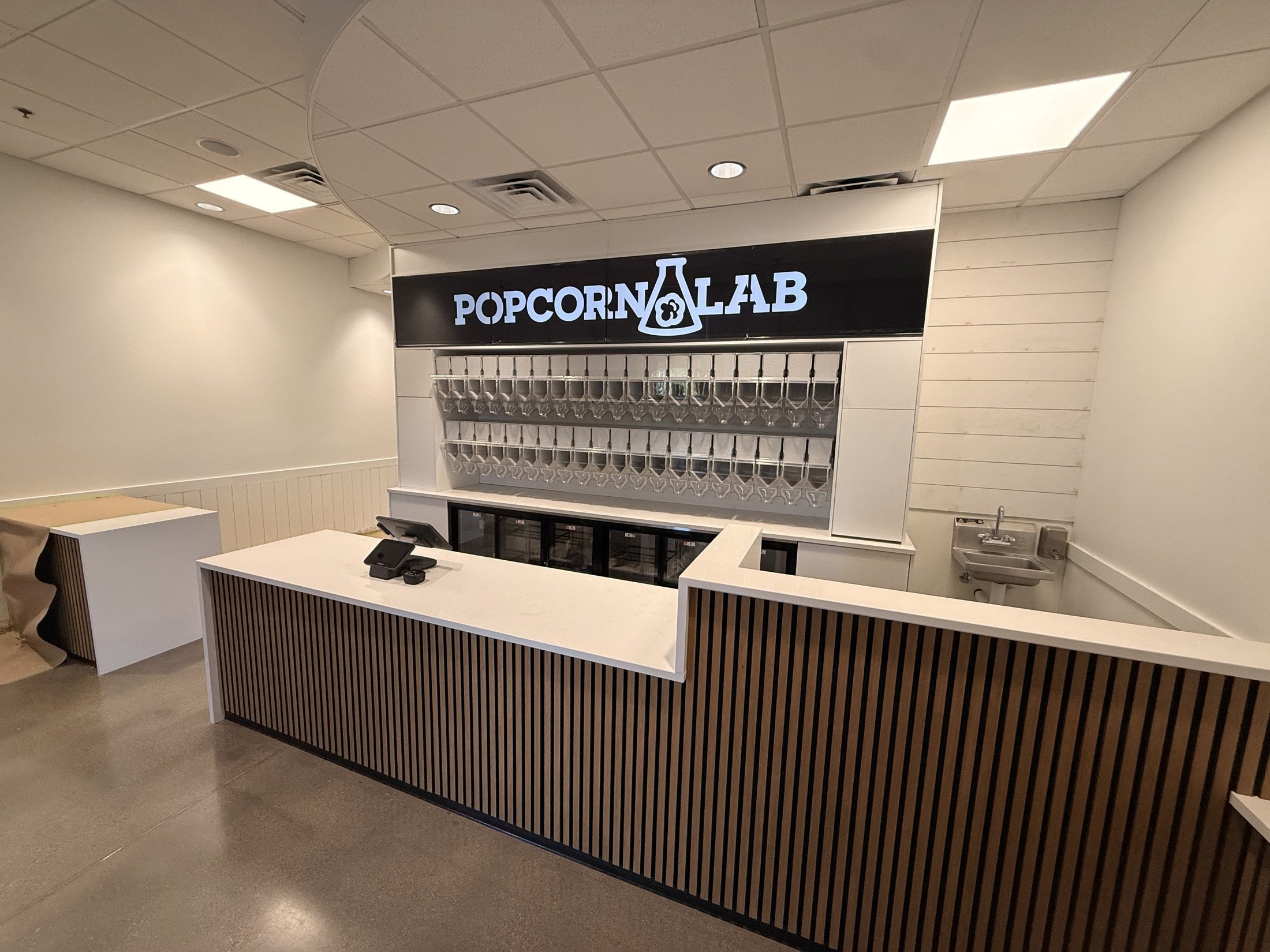 Two rows of Purcell dispensers behind the Popcorn Lab counter